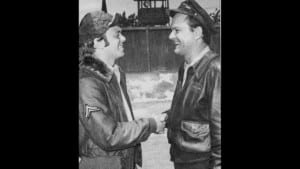 Robert Crane Jr. shaking his dad's hand on the set of Hogan's Heroes.